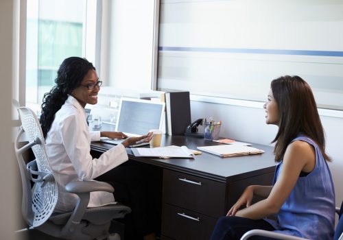 Doctor Wearing White Coat Meeting With Female Patient